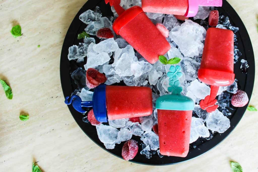 An overhead shot of watermelon strawberry popsicles