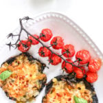 pizza made with portobello mushroom as a base with grilled tomatoes on a vine