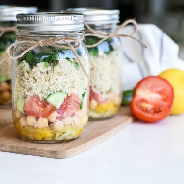 jars filled with layered quinoa chickpea salad