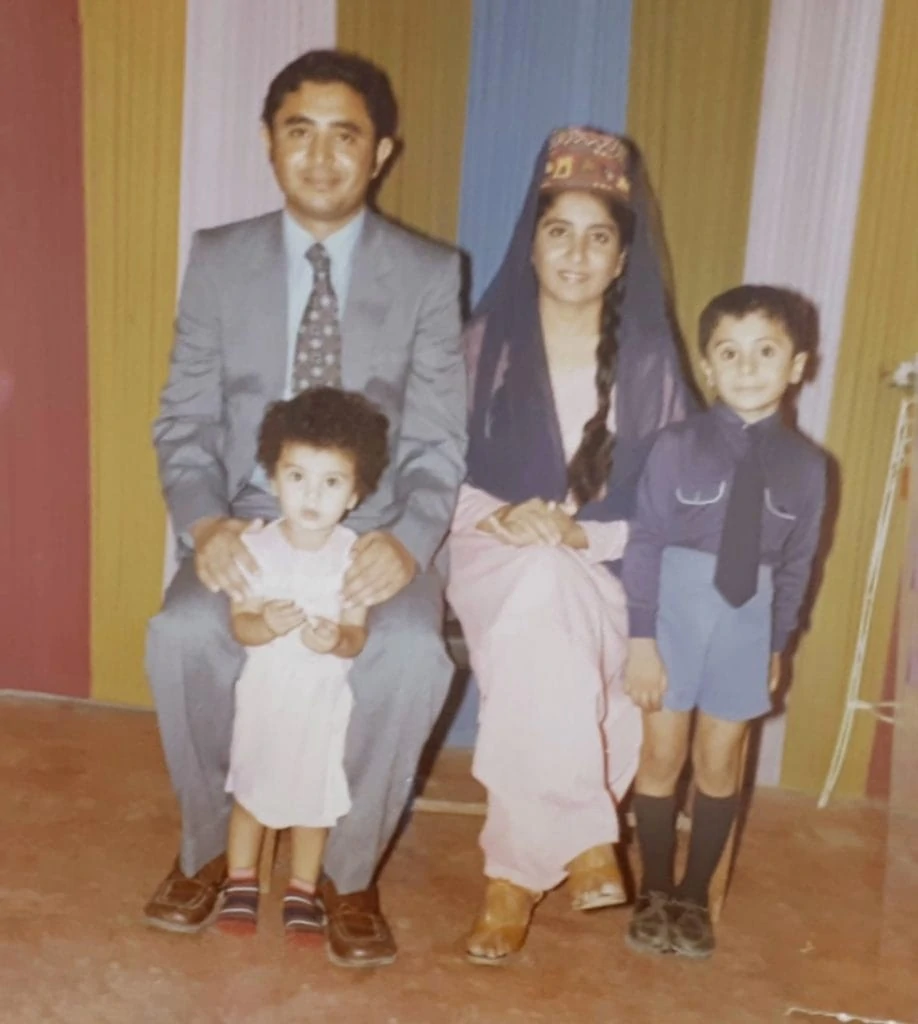 Dietitian, Shahzadi Devje, as a little girl posing for a family portrait with her parents and brother.