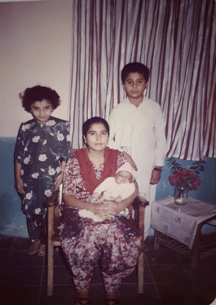 Family portrait of Shahzadi Devje's family in Pakistan with her mum, brother and newly born sister.