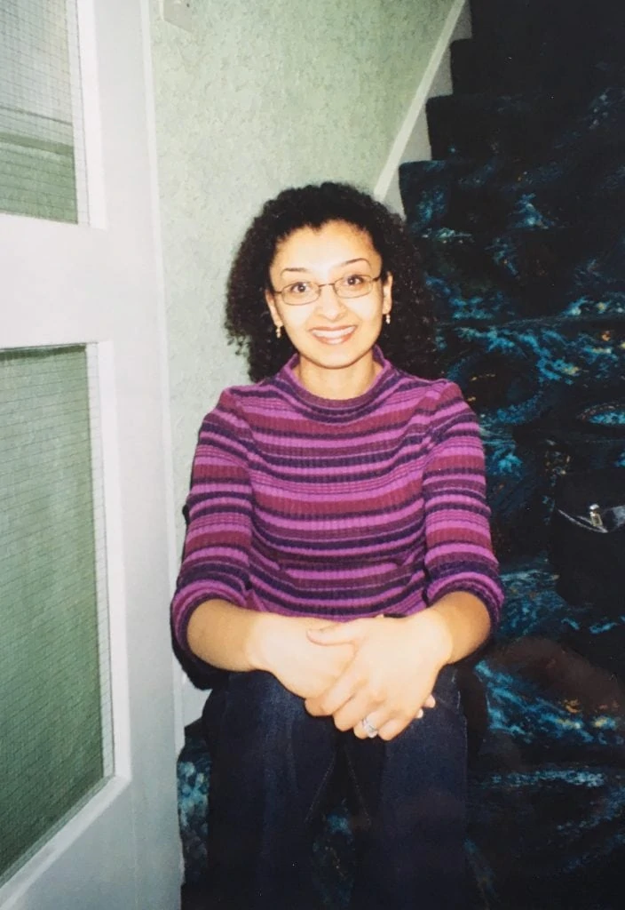 Dietitian Shahzadi Devje, aka Desi~licious RD sitting on a set of stairs in her student days.