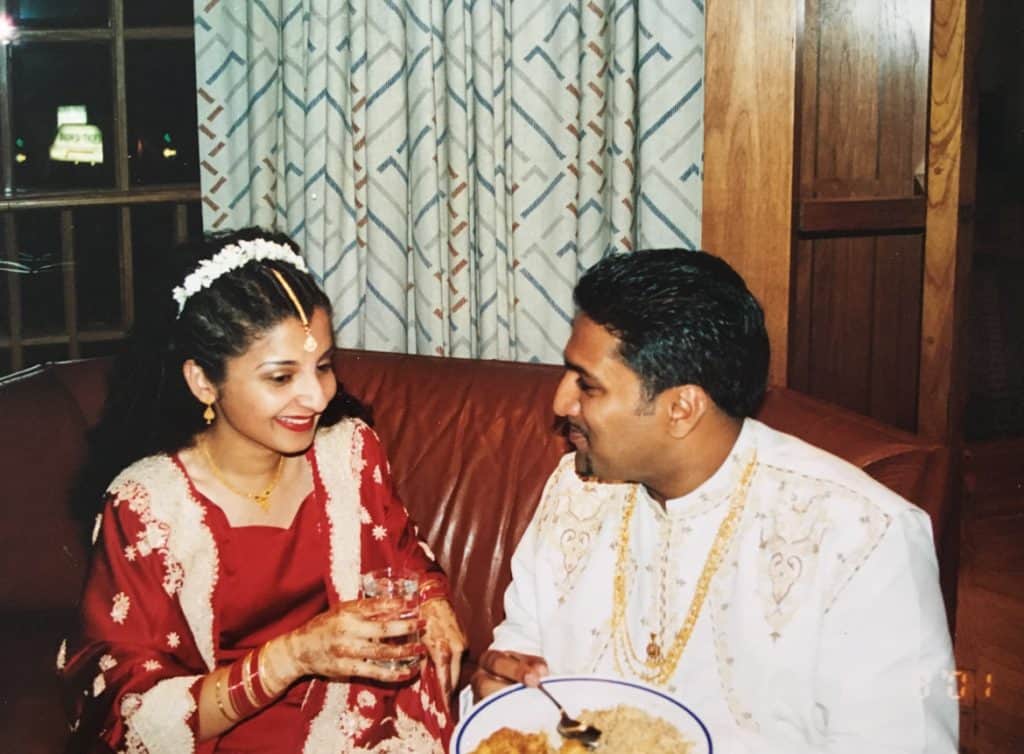 An Desi (South Asian) couple just married in their traditional outfits.