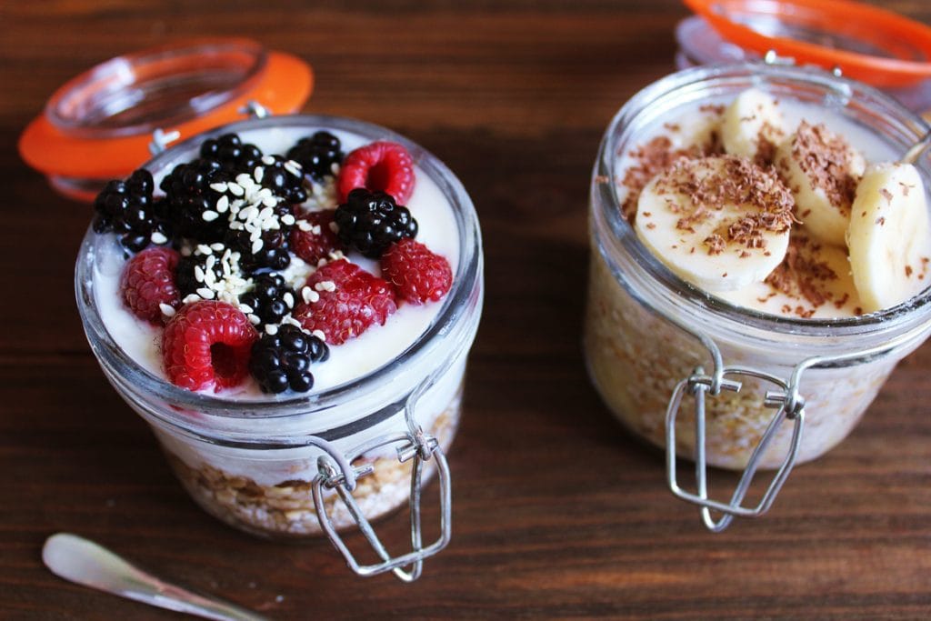 mason jars with yoghurt, fruit and cereal
