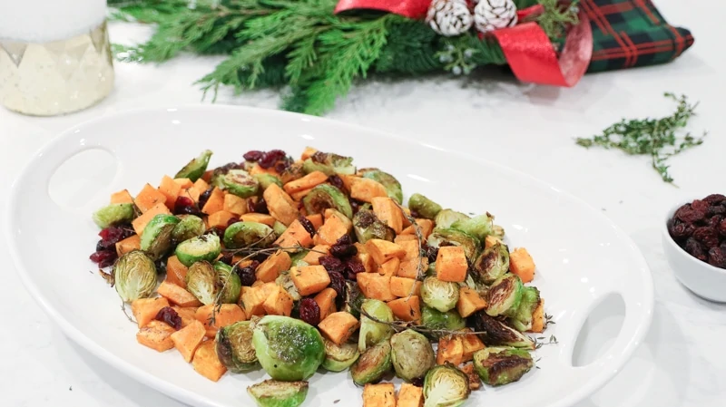 tray of roasted Brussels sprouts with sweet potatoes and dried cranberries