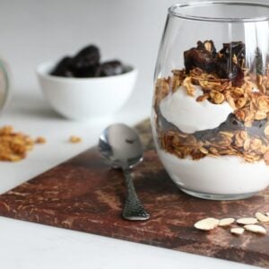 homemade granola parfait layered with yoghurt and dried prunes