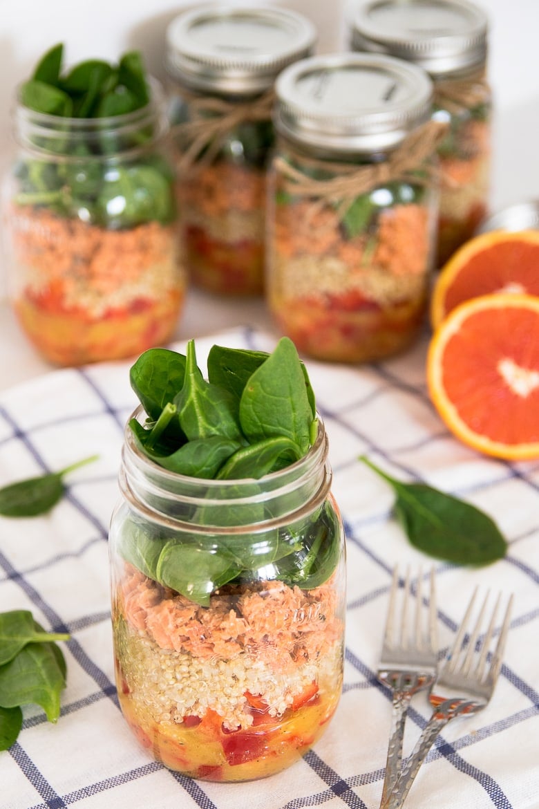 quinoa and salmon salad stored in five mason jars