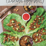 lettuce leaves filled with baingan bharta (Indian eggplant recipe) with a bowl of baingan bharta in the center.