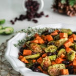 Plate of easy and healthy roasted Brussel sprouts recipe with sweet potatoes and cranberries