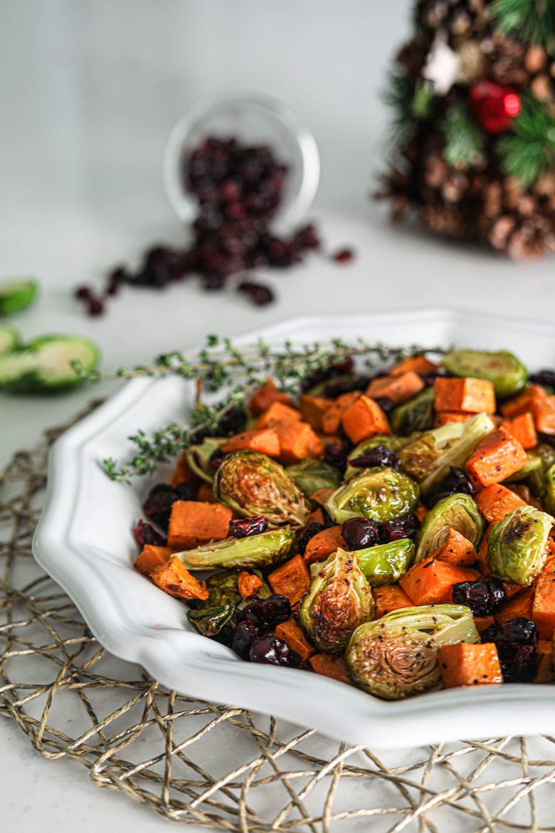 Plate of easy and healthy roasted Brussel sprouts recipe with sweet potatoes and cranberries