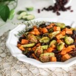 Plate of easy and healthy roasted Brussel sprouts recipe with sweet potatoes and cranberries