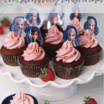 a collection of chocolate cupcakes with strawberry buttercream on a cake stand with Frozen princess toppers