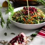 bowl of easy salad recipe with colourful vegetables and topped with pomegranate and seeds surrounded by vegetables