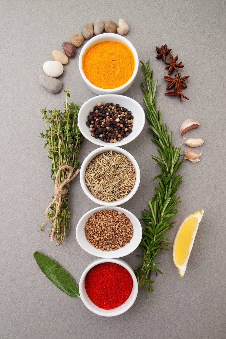 Various spices on a gray background.