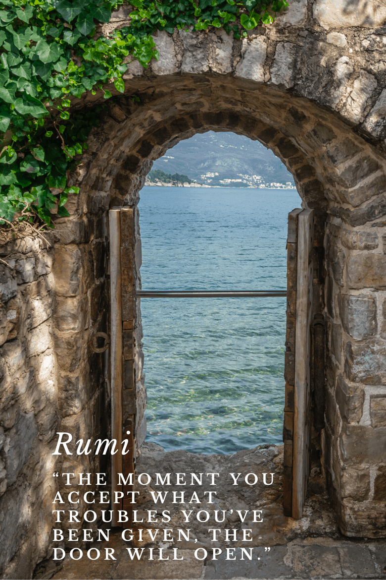 A door opening to the view of the sea with a quote of Rumi