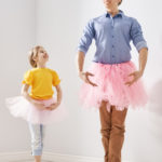 Happy father's day! Dad and his daughter child girl are playing, smiling and dancing. Family holiday and togetherness.