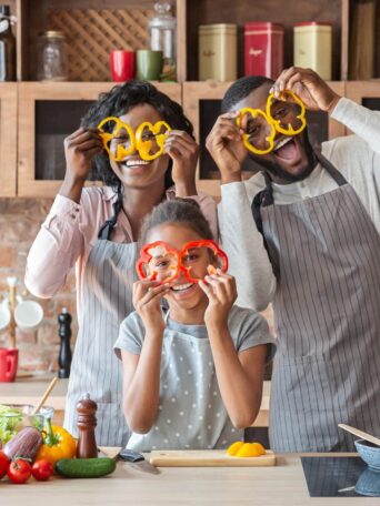 Kitchen Fun. Sweet African Family Having Fun While Cooking, wearing pepper glasses, copy space