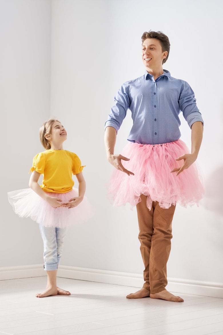 Happy father's day! Dad and his daughter child girl are playing, smiling and dancing. Family holiday and togetherness.