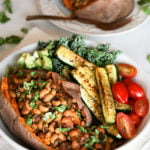 vegan black eyed peas recipe stuffed in a sweet potato with colourful vegetables in a bowl