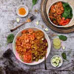 Bowl of vegetable quinoa with garlic shrimp recipe flat-lay