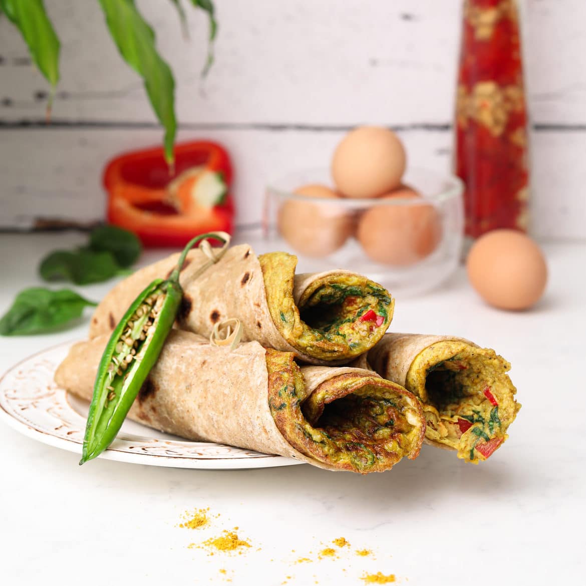 three stacked roti rolls with a desi (south asian) omelette in each