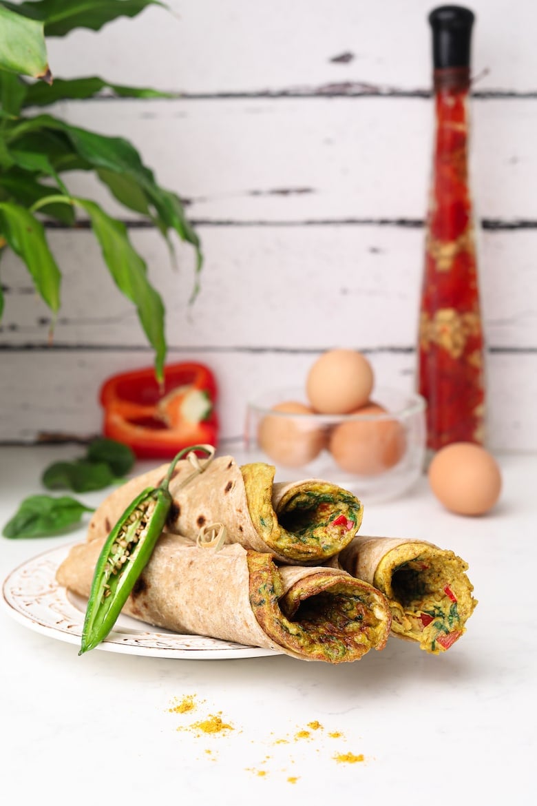 three stacked roti rolls with a desi (south asian) omelette in each