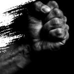 Fist of a Black person against a black background