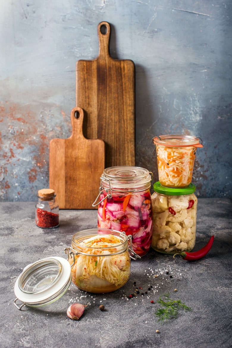 Fermented cabbage, fermented vegetables, kimchi in glas jars, marinated canned food, natural probiotics, healthy eating, prebiotic rich food for digestion and healthy gut, vegan food