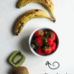 flat lay of fresh fruits: bananas, kiwi and a bowl of strawberries