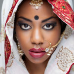 Young Indian woman dressed in traditional clothing with bridal makeup and jewelry