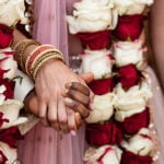 Detail of hands and clothing during Indian wedding ceremony.