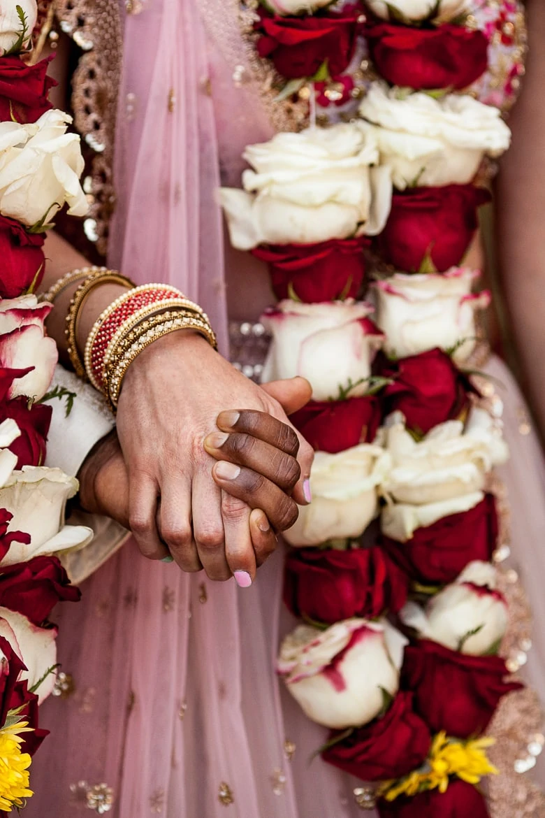 Detail of hands and clothing during Indian wedding ceremony.