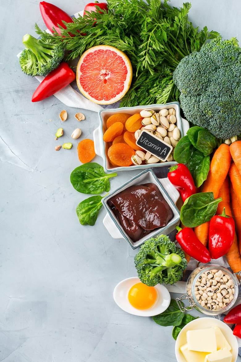 Balanced diet nutrition, healthy clean eating concept. Assortment of food sources rich in vitamin a on a kitchen table. Copy space background