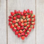 Strawberries ripe of heart on old wood.