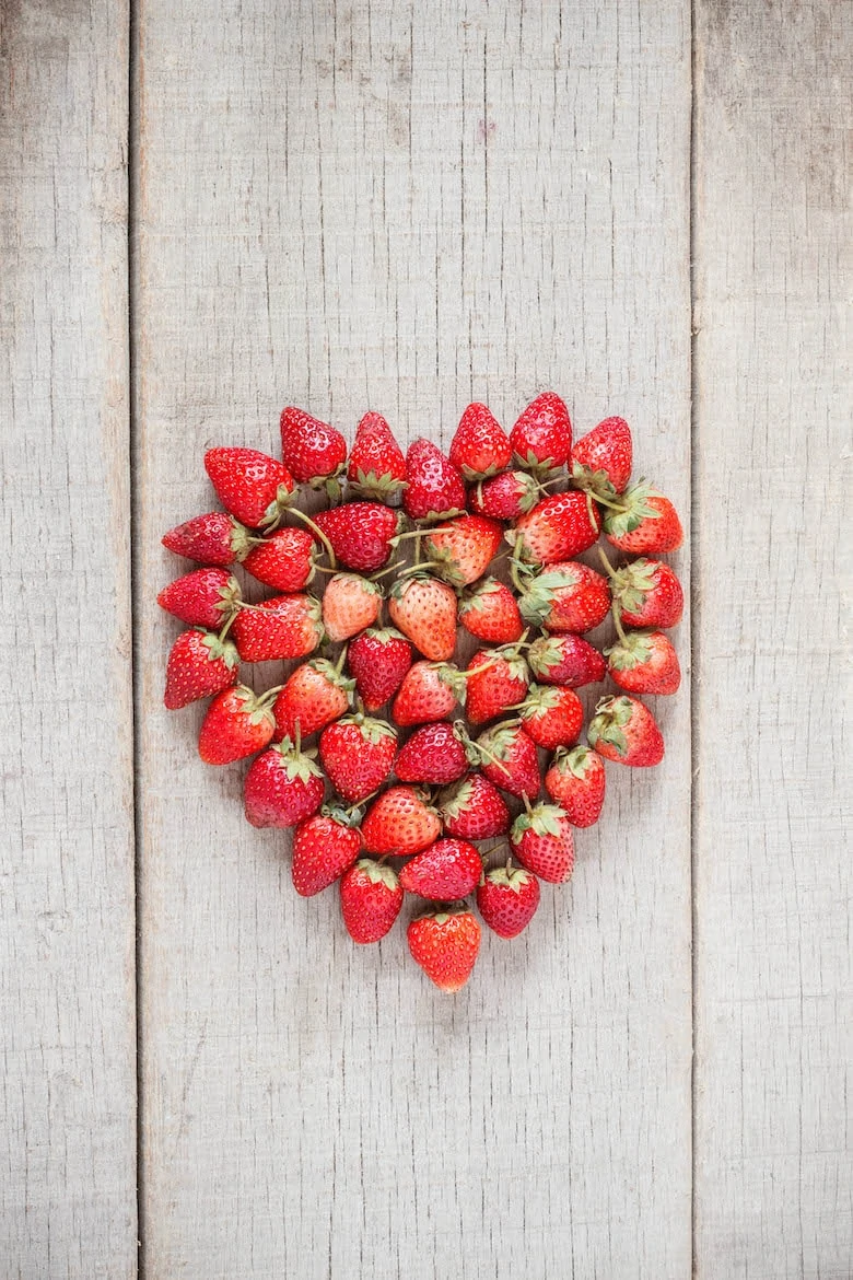 Strawberries ripe of heart on old wood.