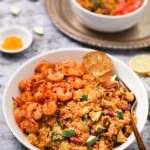 Bowl of vegetable quinoa with garlic shrimp recipe side angle