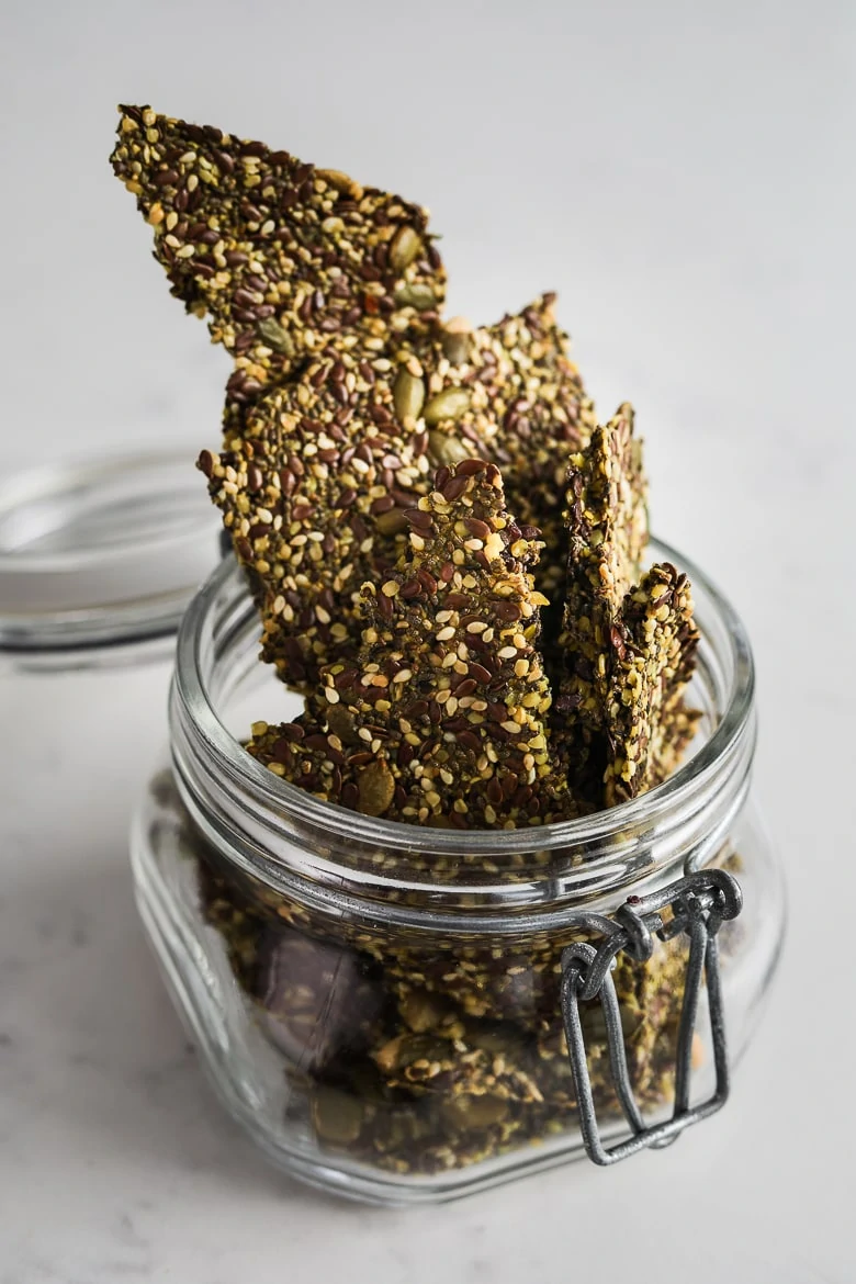 jar overflowing with homemade seeded crackers