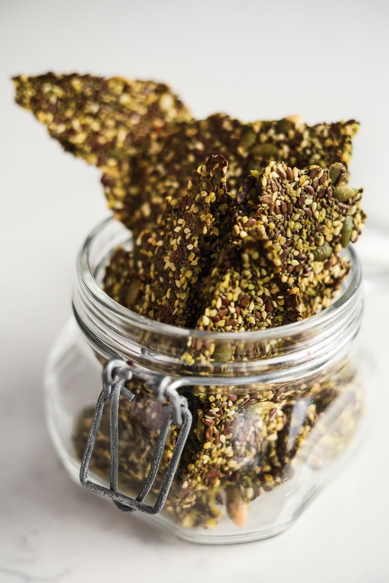 jar overflowing with homemade seeded crackers