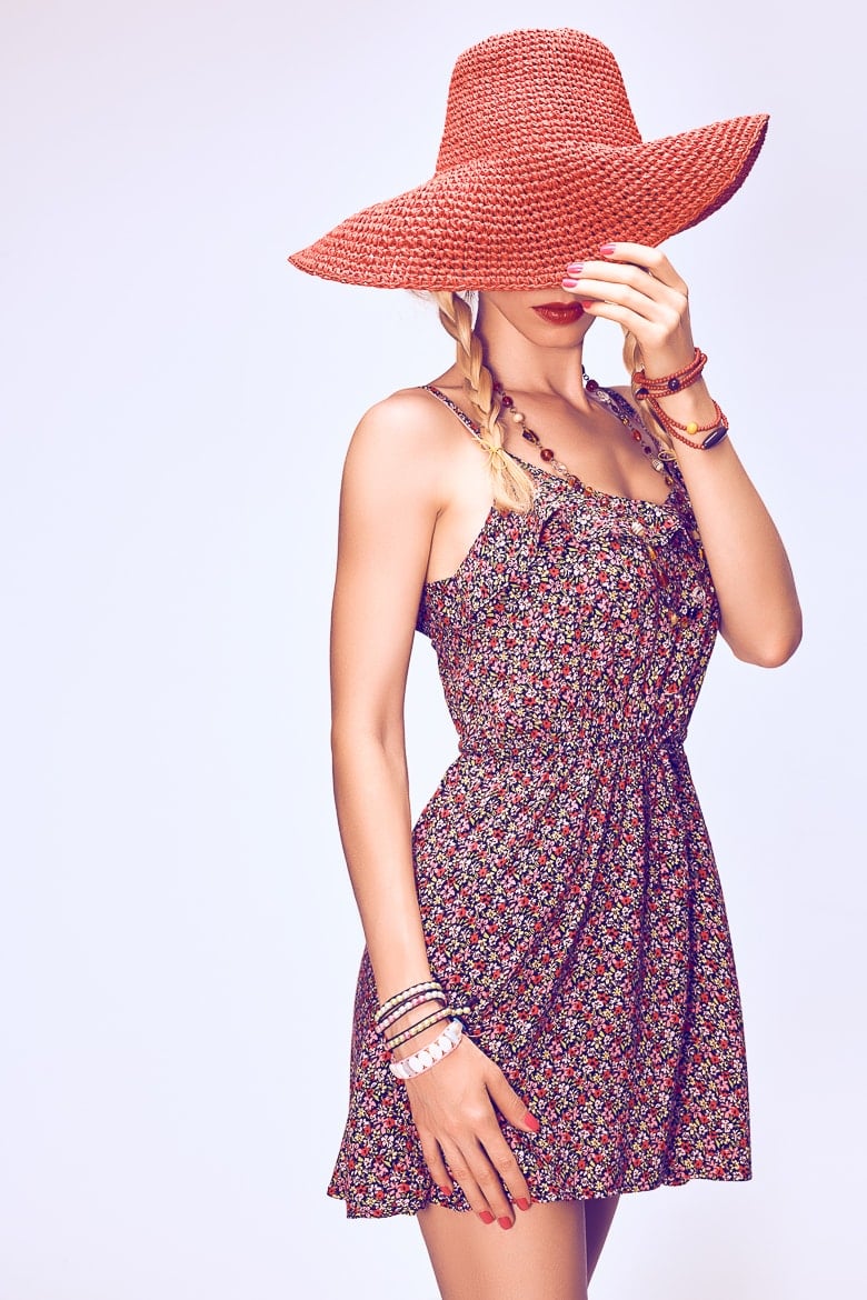 Hippie Boho woman Having Fun. Playful positive Model, Summer Fashion Outfit. Blonde in Trendy Sundress, pigtails, ethnic Fashion Accessories. Hat covers girl face, romantic Style.Unusual creative look