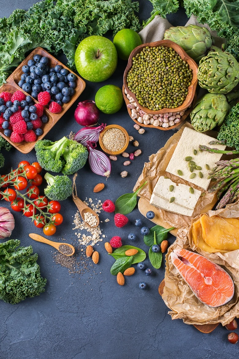 Selection assortment of healthy balanced food for heart, diet, detox, salmon fish, chicken breast, tofu, seeds nuts broccoli green spinach asparagus, berries. Top view flat lay overhead