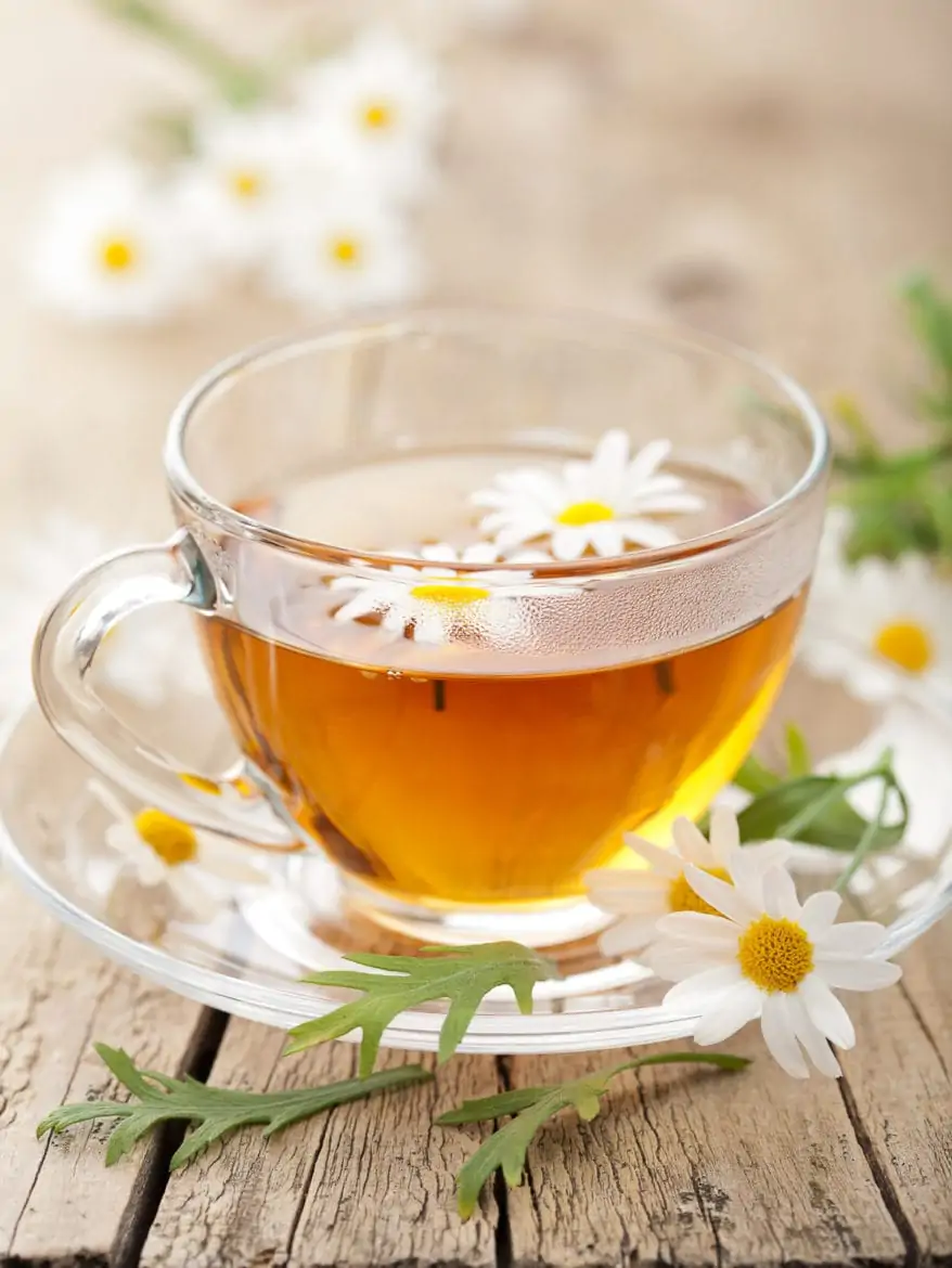 cup of herbal tea with chamomile flowers as a natural way to fall asleep