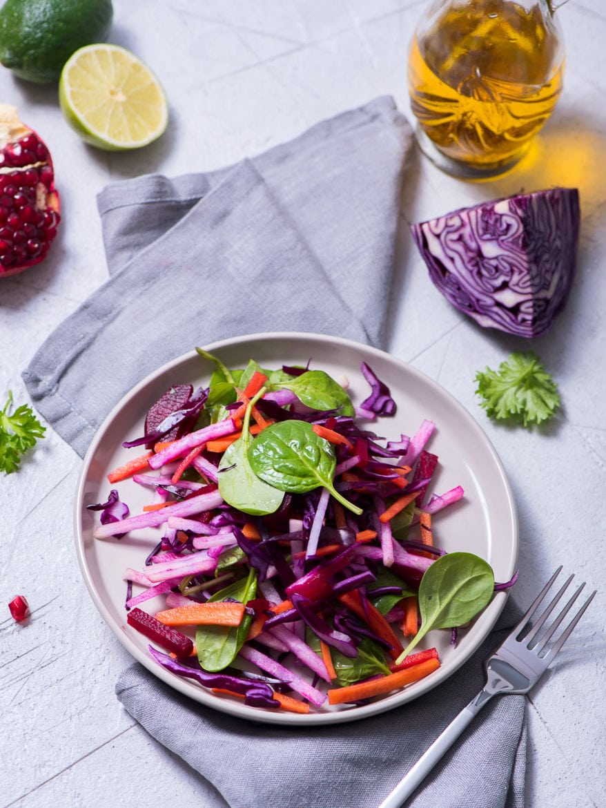 Healthy winter salad with red cabbage, carrot, beetroot, spinach, pomegranate, vitamin food