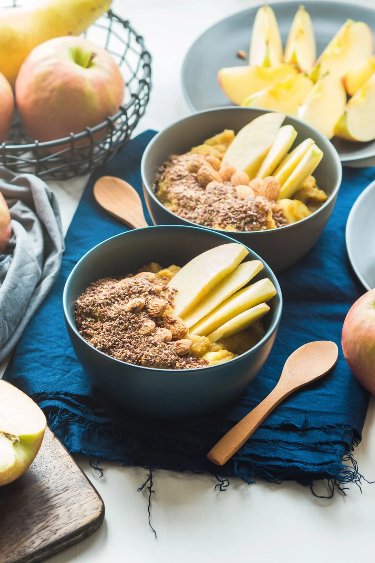 Turmeric amaranth porridge served with apples, flax seeds and almonds. Healthy plant based vegan breakfast.