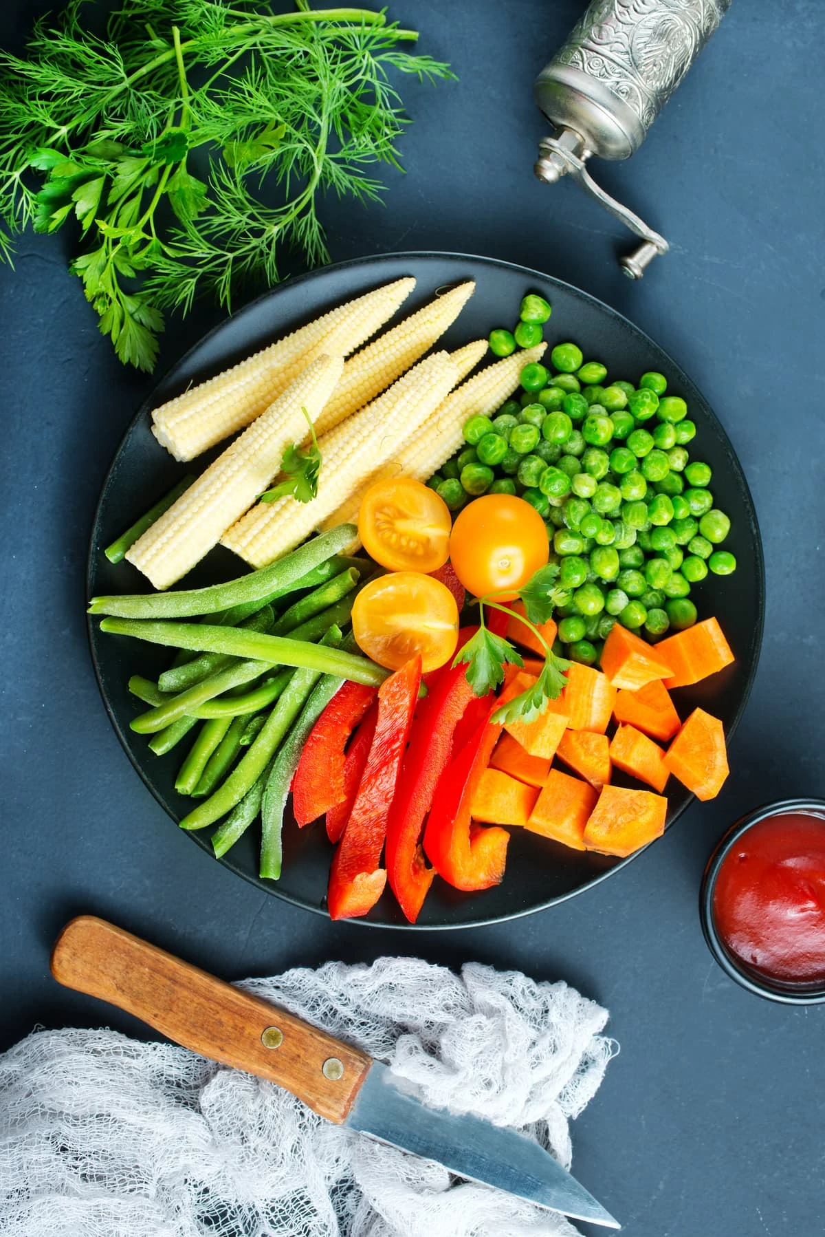 Fresh vegetables, raw vegetables on black plate.