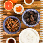 ramekins of ingredients filled with dates, pecans, yogurt, brown liquids and orange zest.