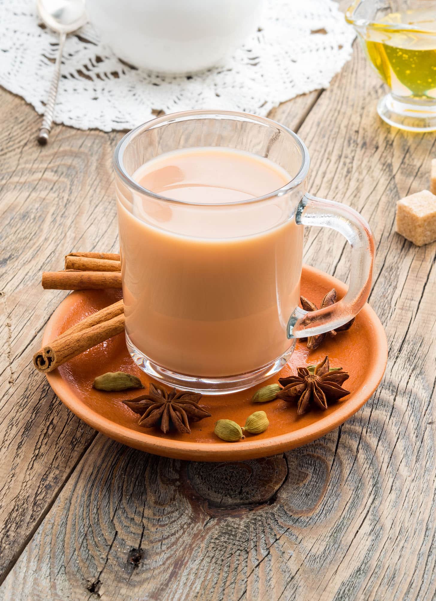 Masala Indian drink in the festival of Holi. Tea with milk and spices in a glass mug.
