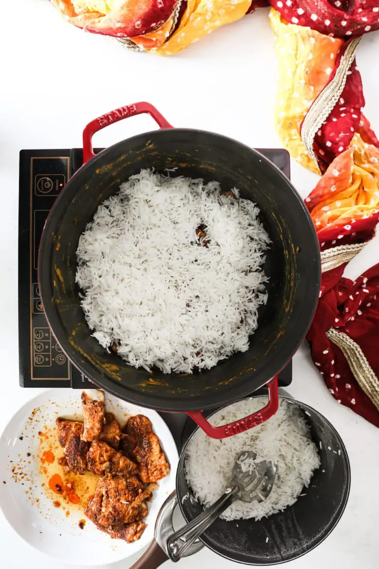 a large pot with rice on a portable stove.