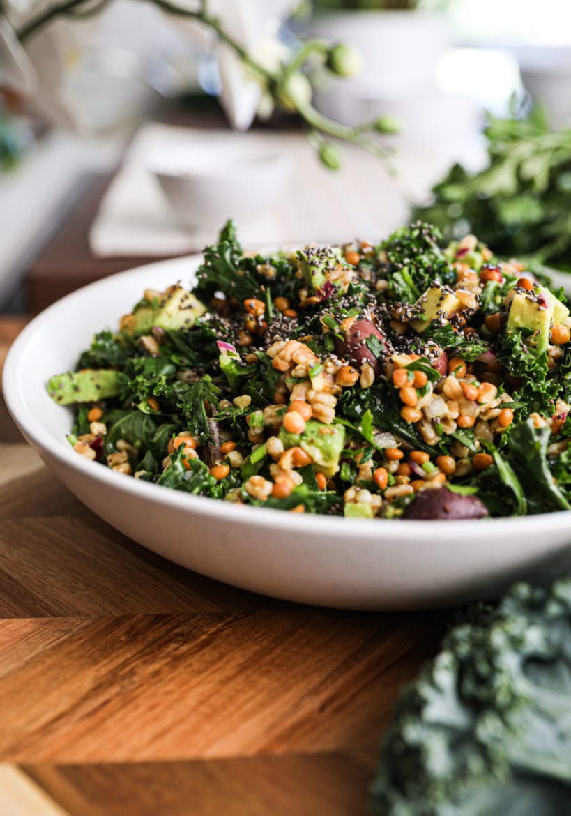 side shot of a green salad with grains.