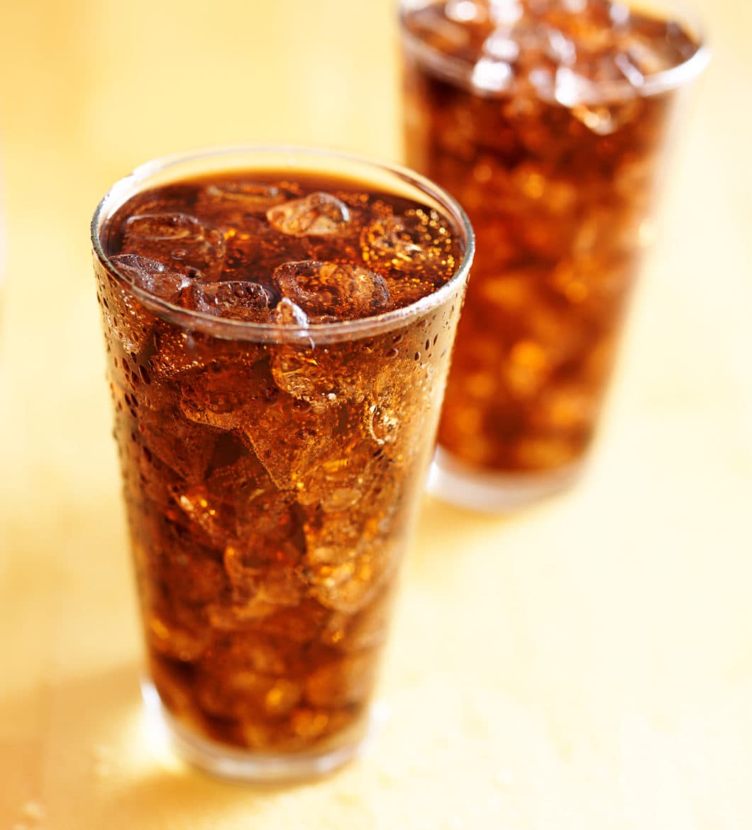 two glass cups of cola soda with ice