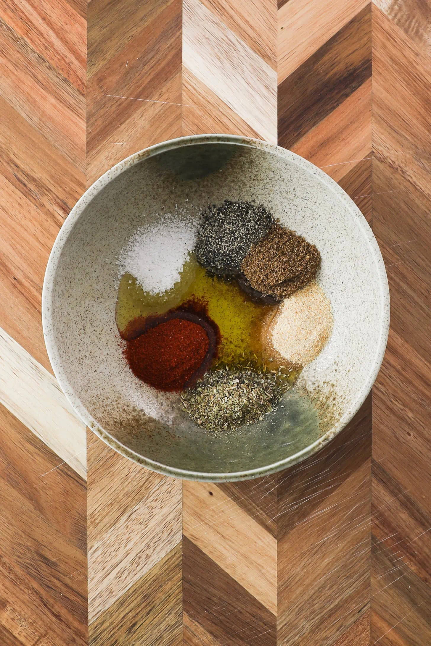 a bowl of spices and oil.